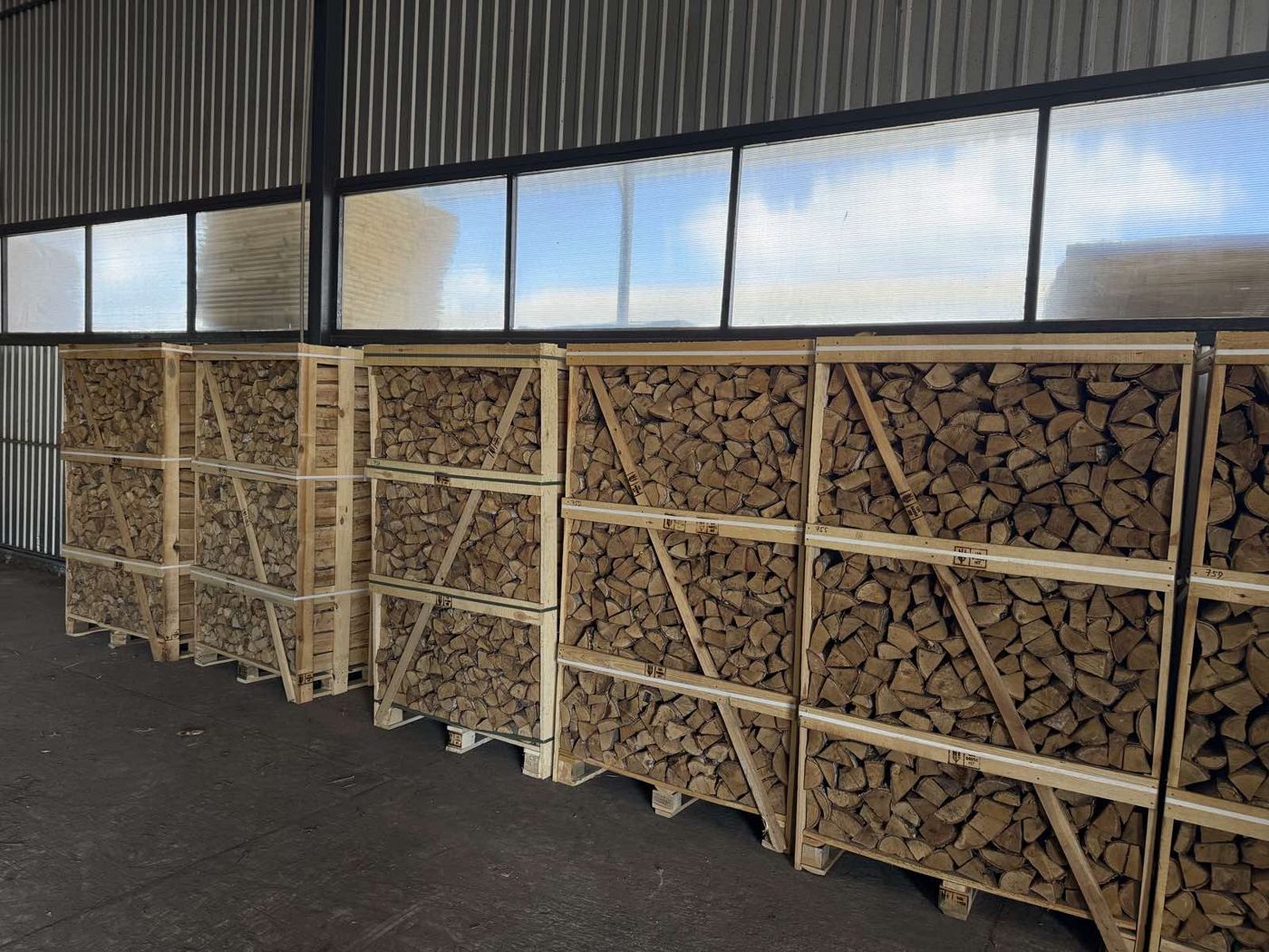 Crates of oven-dried birch firewood in a warehouse