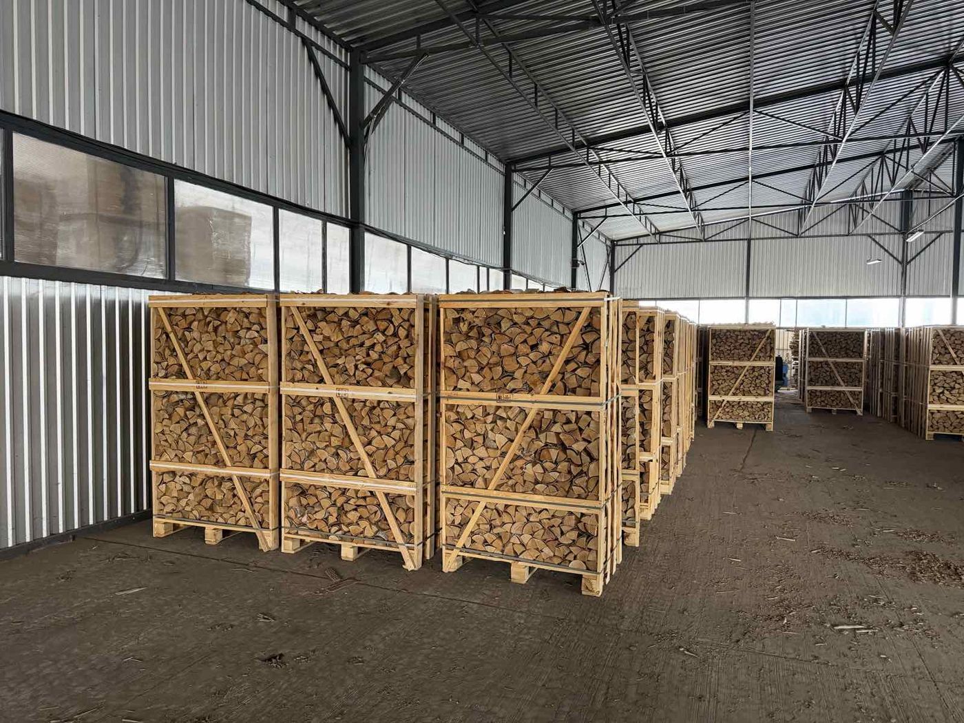 Warehouse with crates of kiln-dried firewood ready for loading